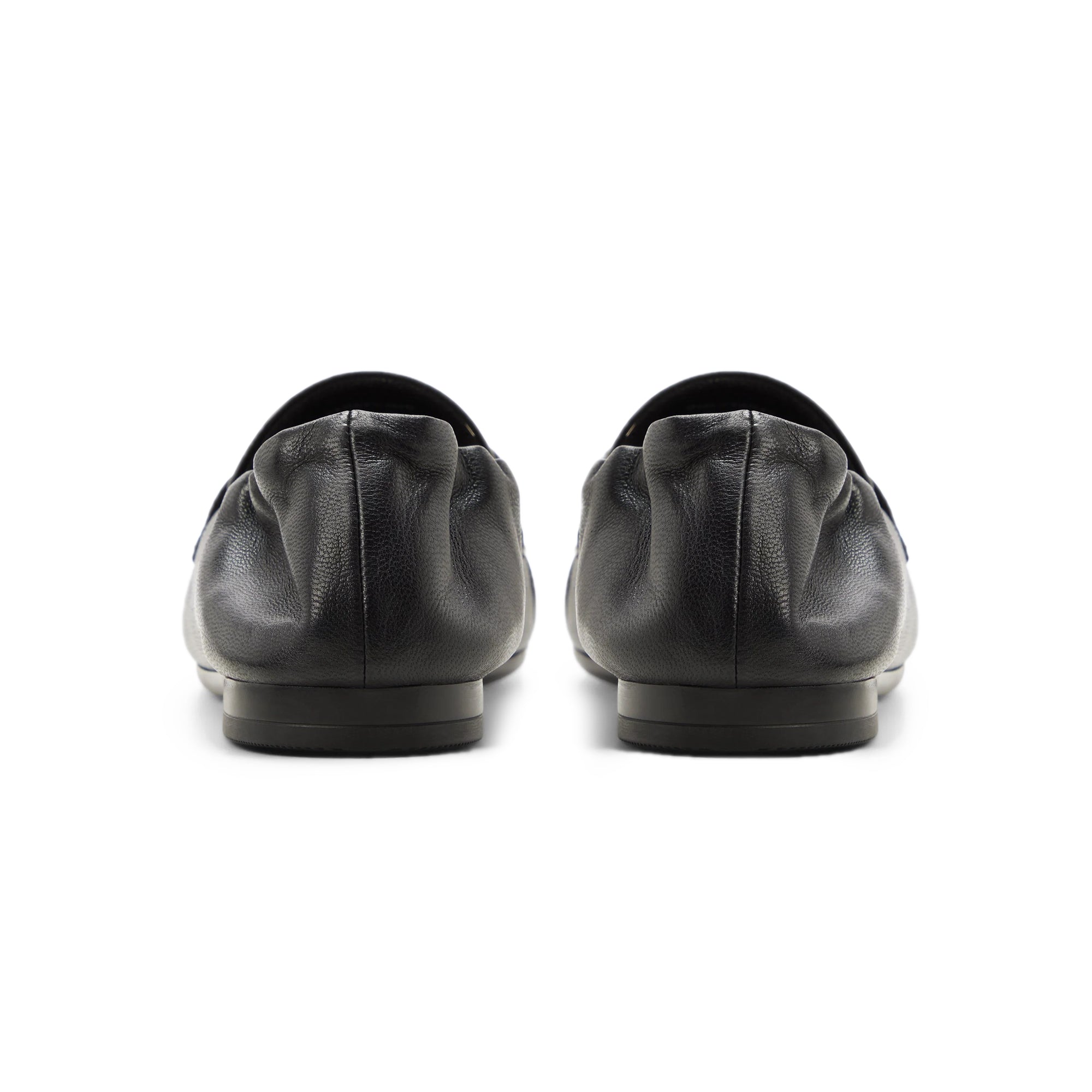 black penny loafers on a white background