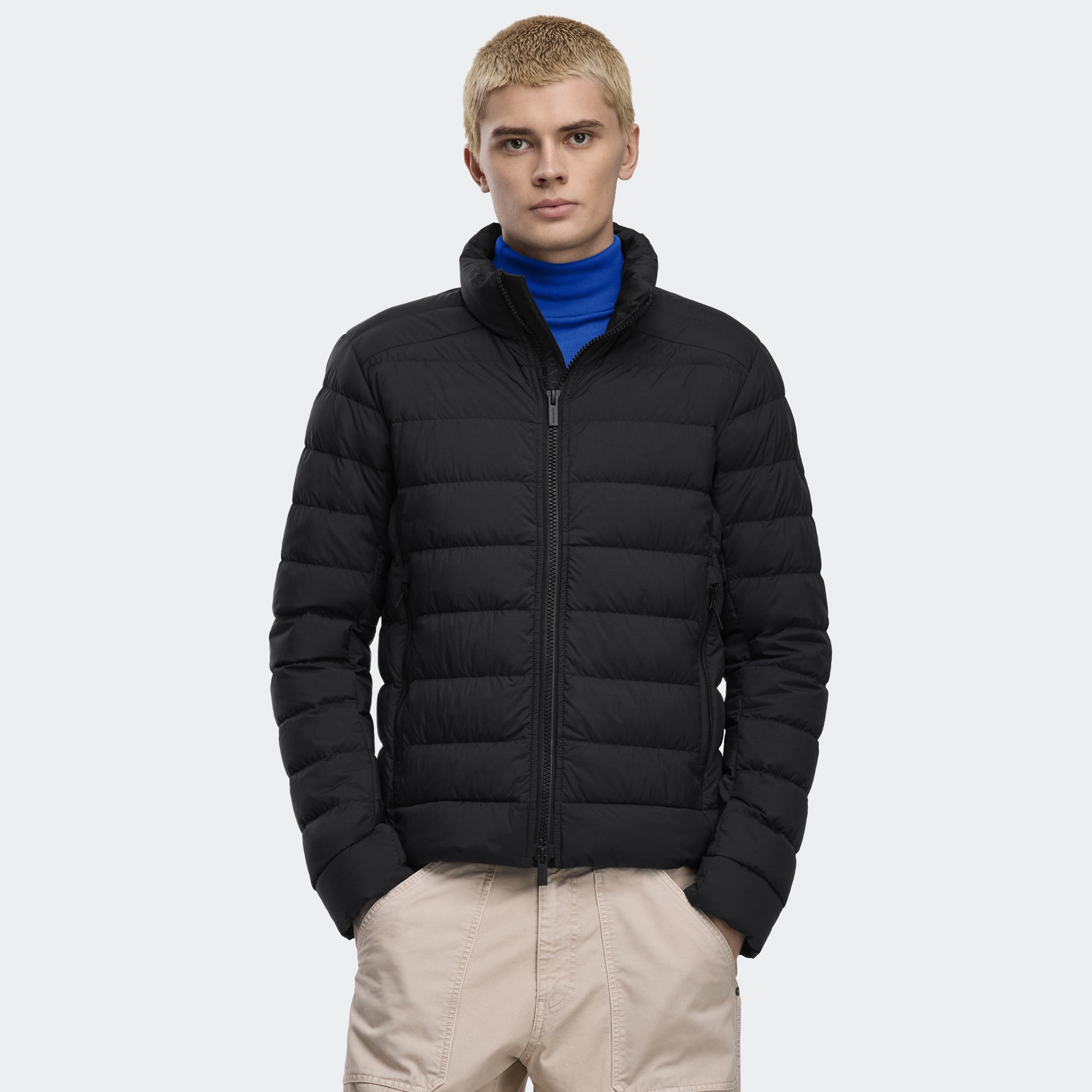 person wearing a black jacket on a white background