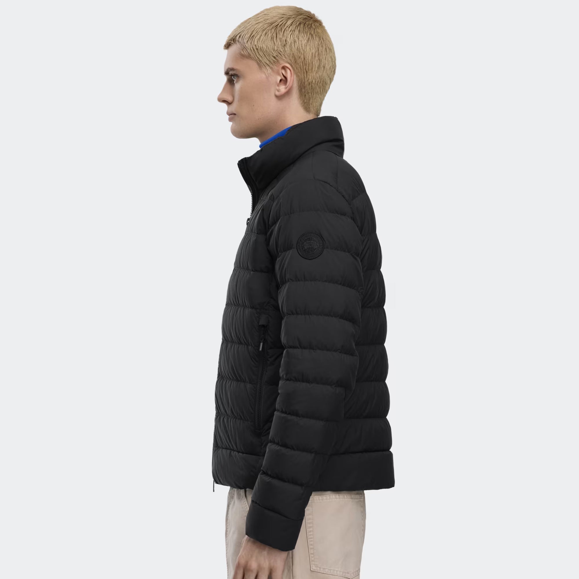 person wearing a black jacket on a white background