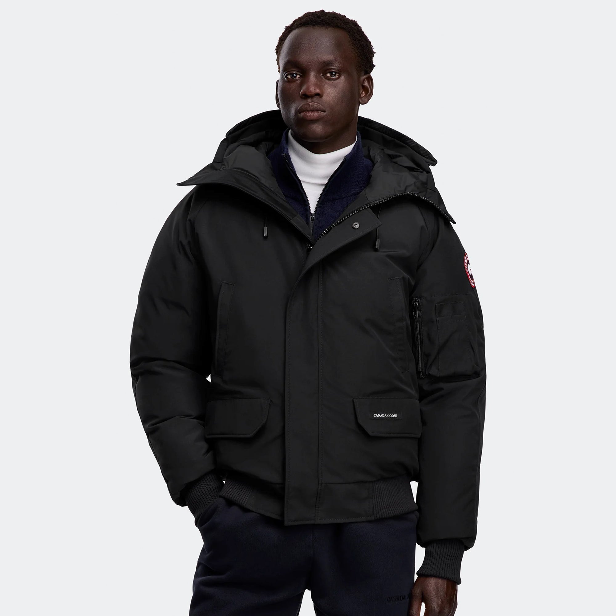 person wearing a black jacket on a white background