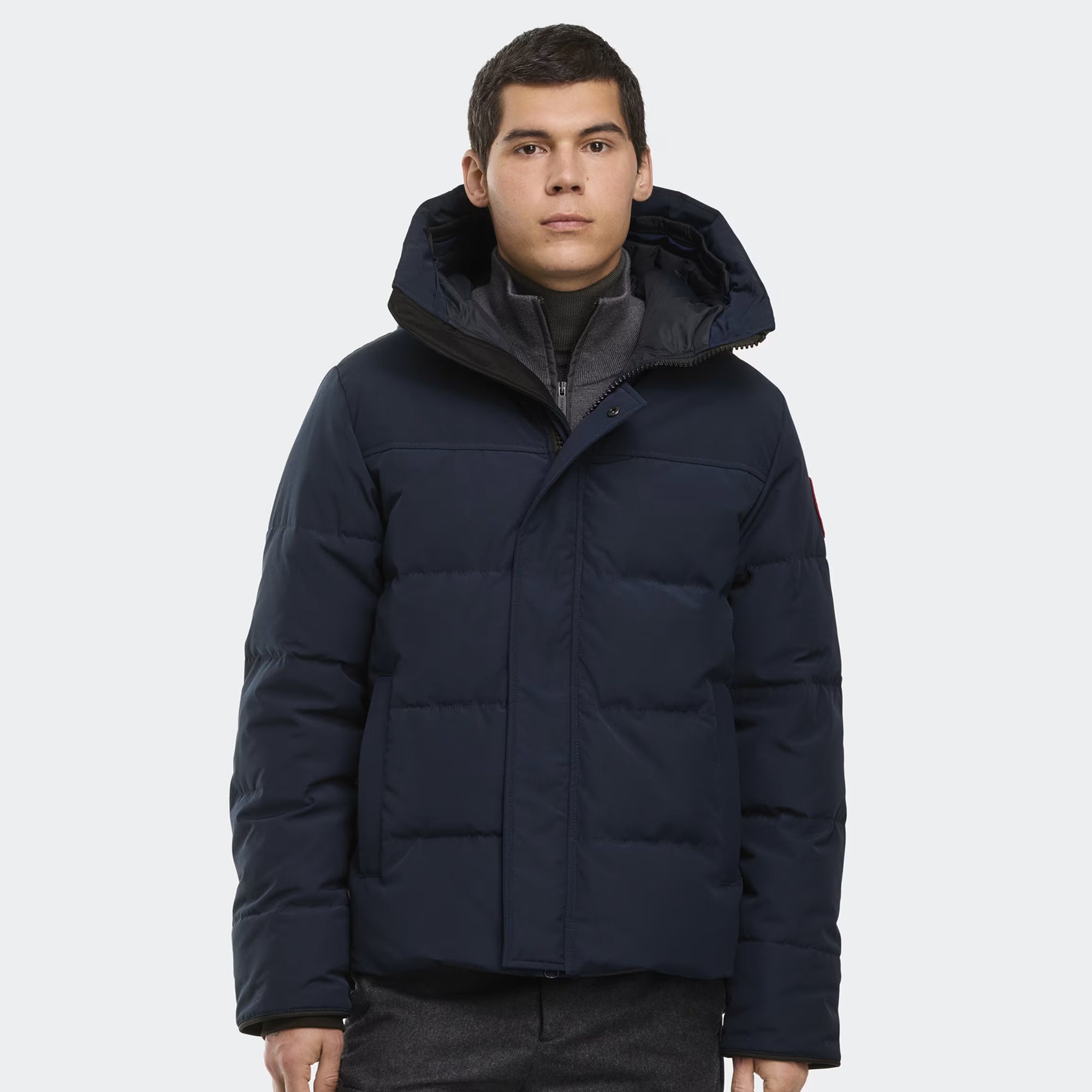 person wearing a navy and black jacket on a white background