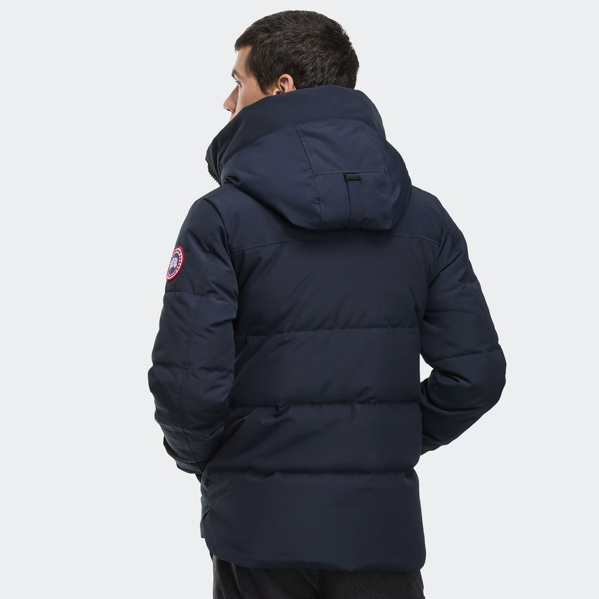 person wearing a navy and black jacket on a white background