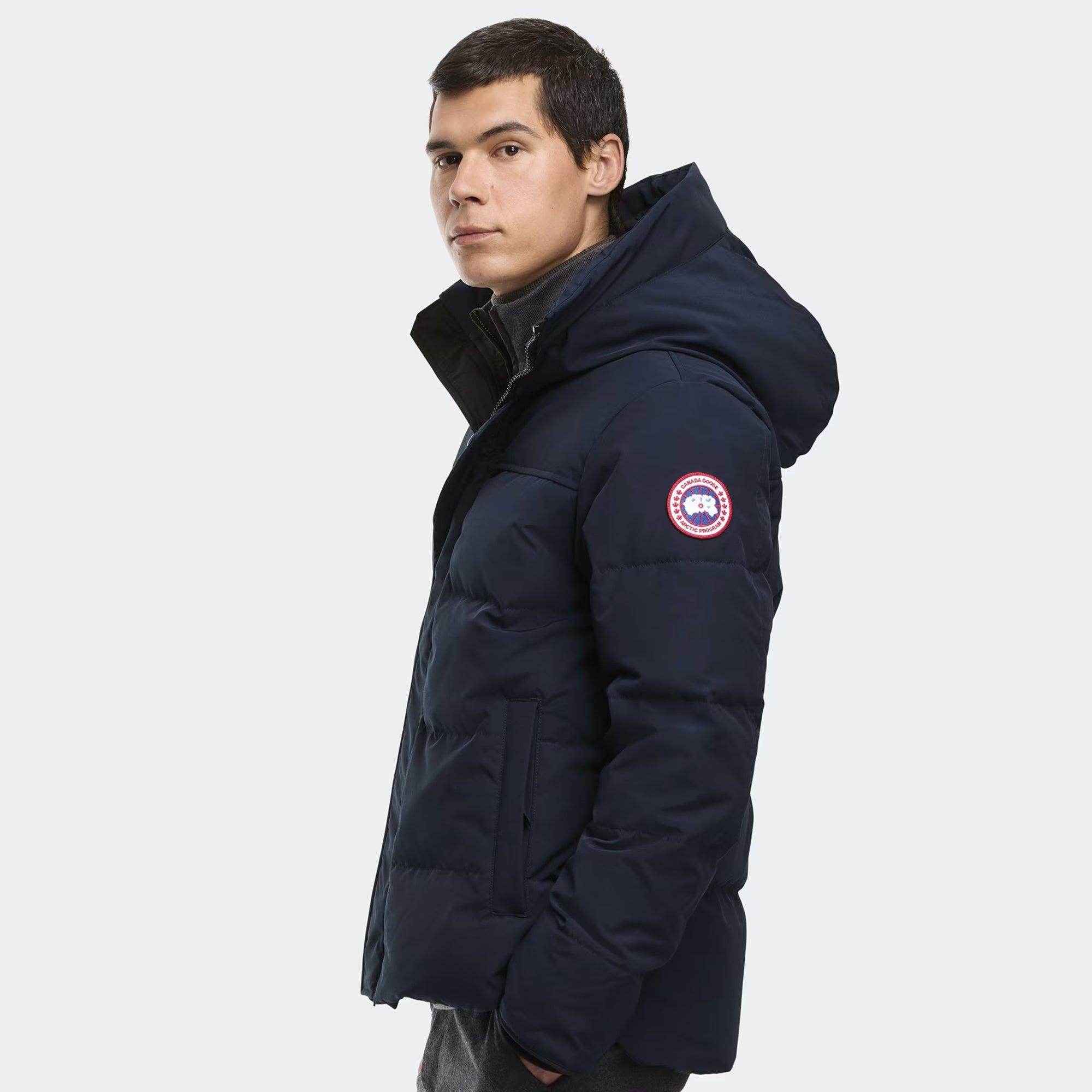person wearing a navy and black jacket on a white background