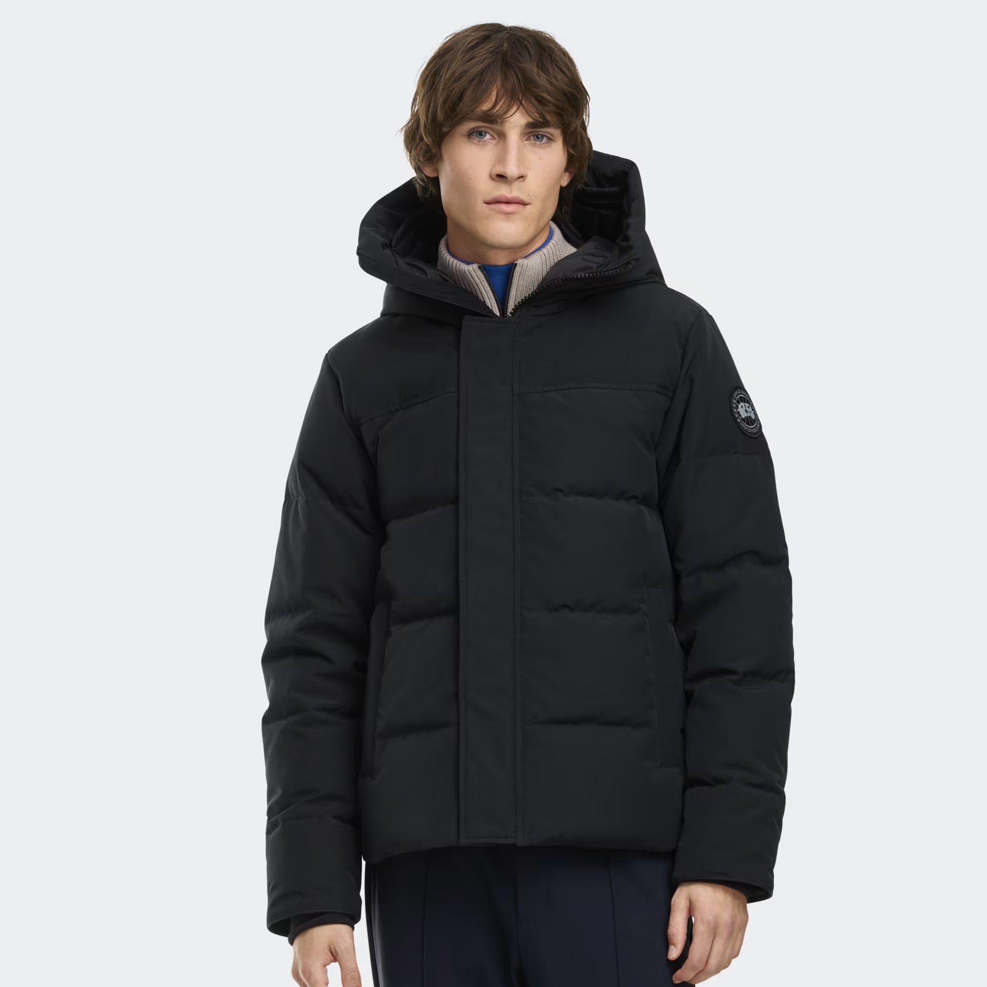 person wearing a black jacket on a white background
