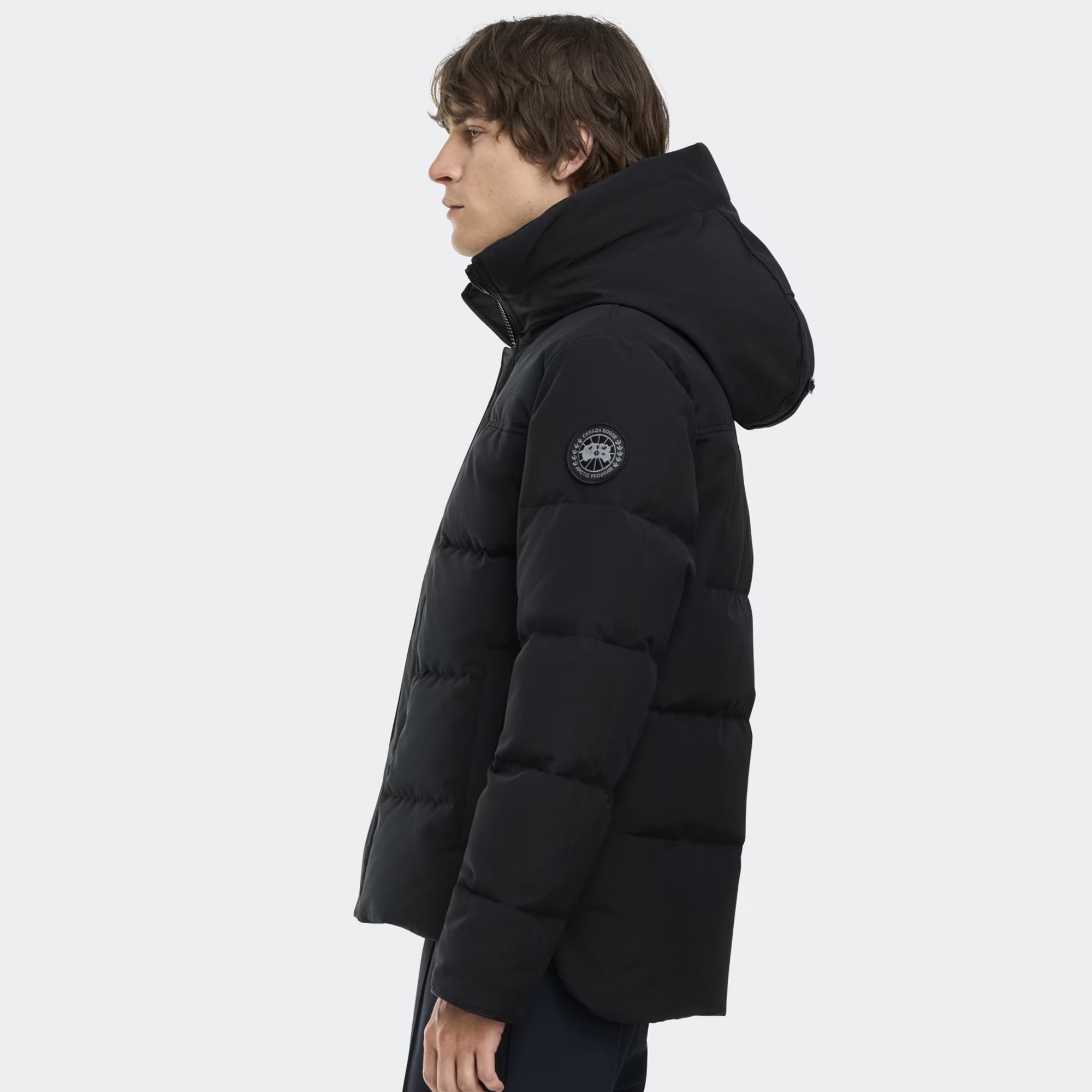 person wearing a black jacket on a white background
