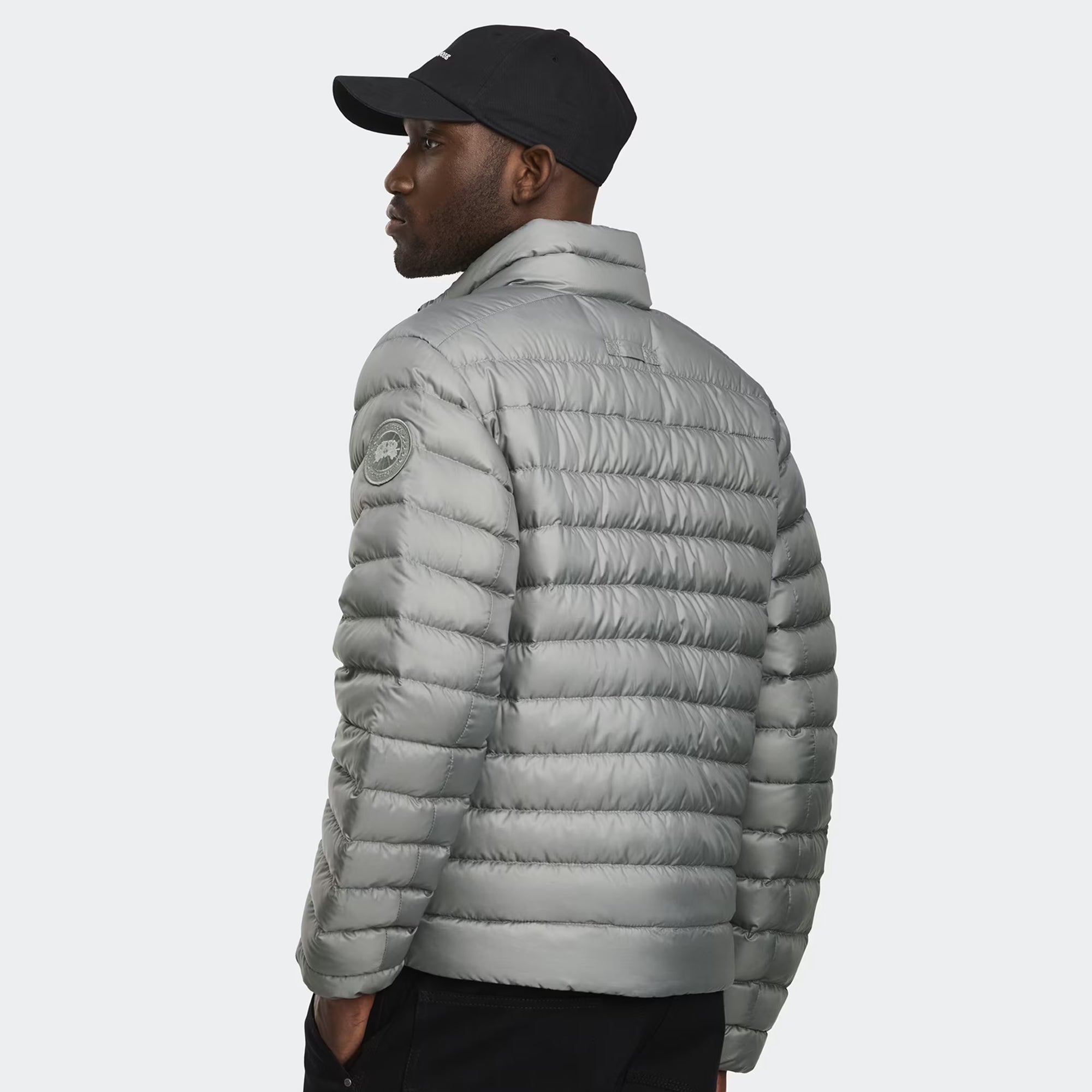person wearing a grey jacket on a white background