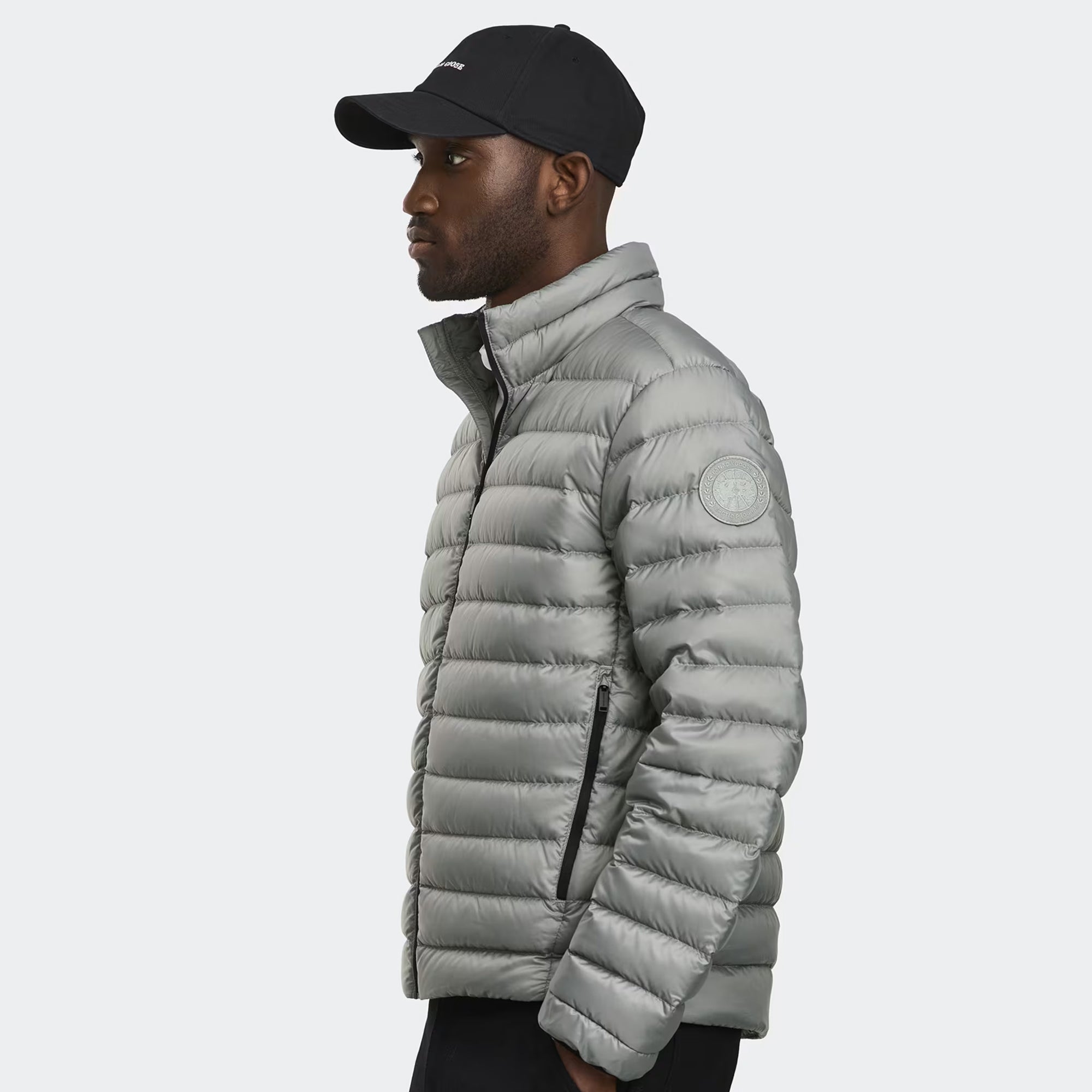 person wearing a grey jacket on a white background