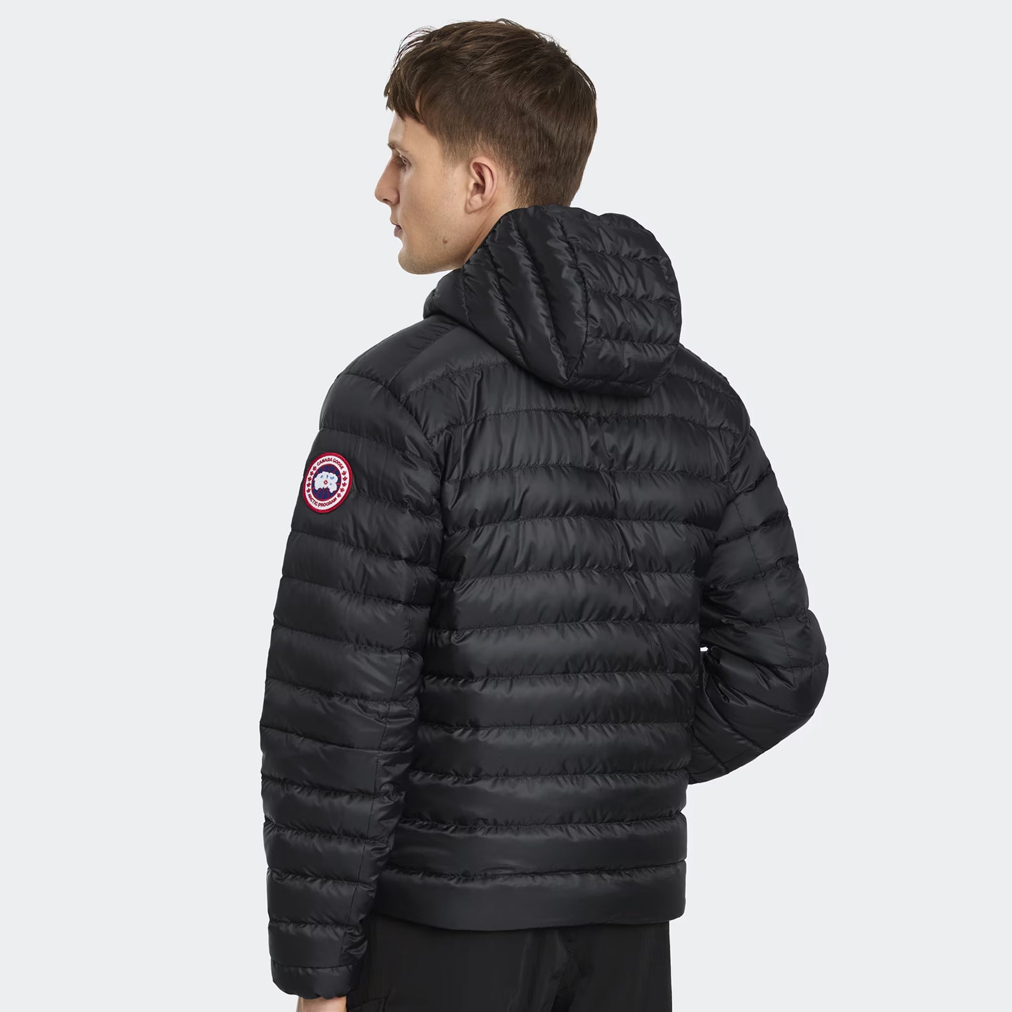 person wearing a black jacket on a white background