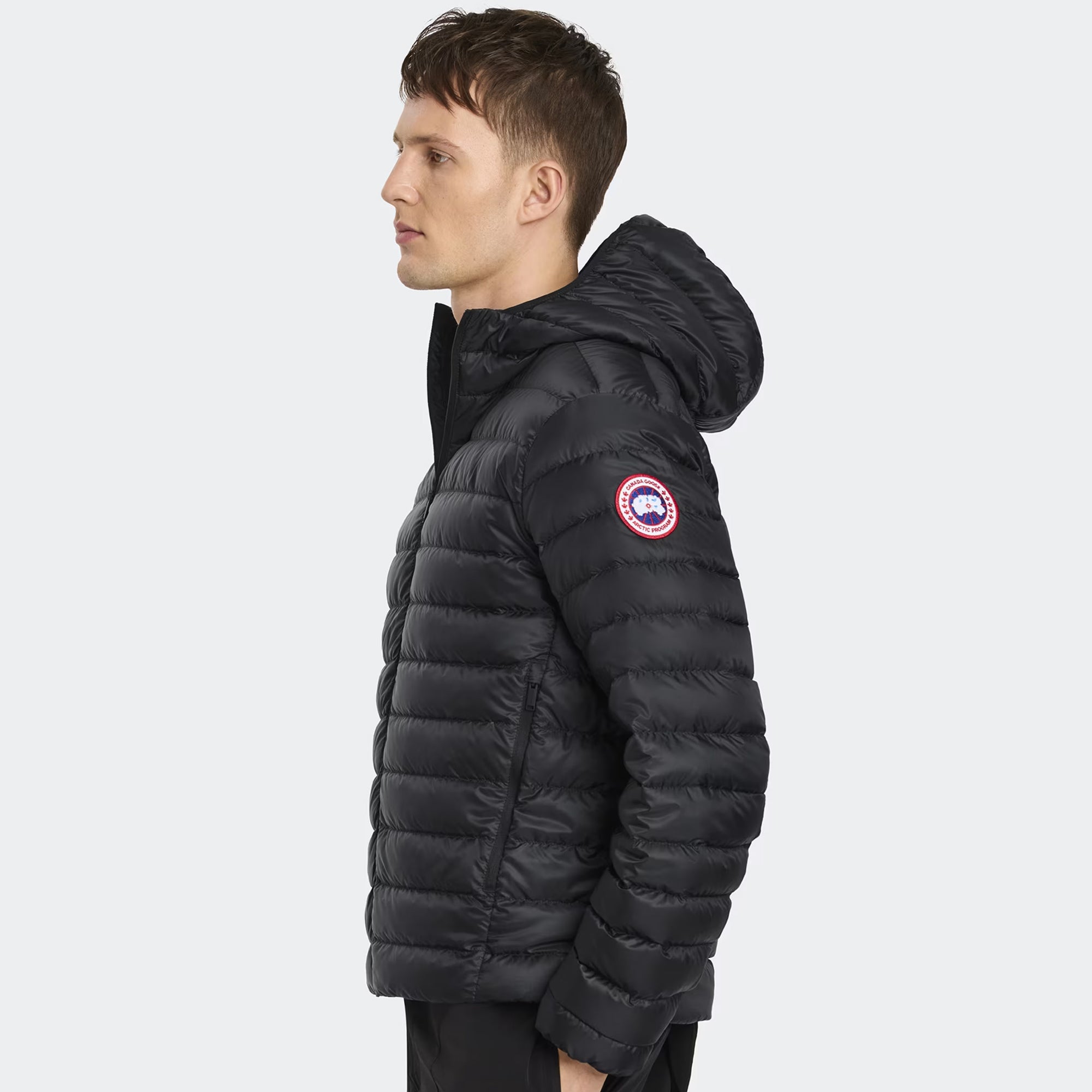 person wearing a black jacket on a white background