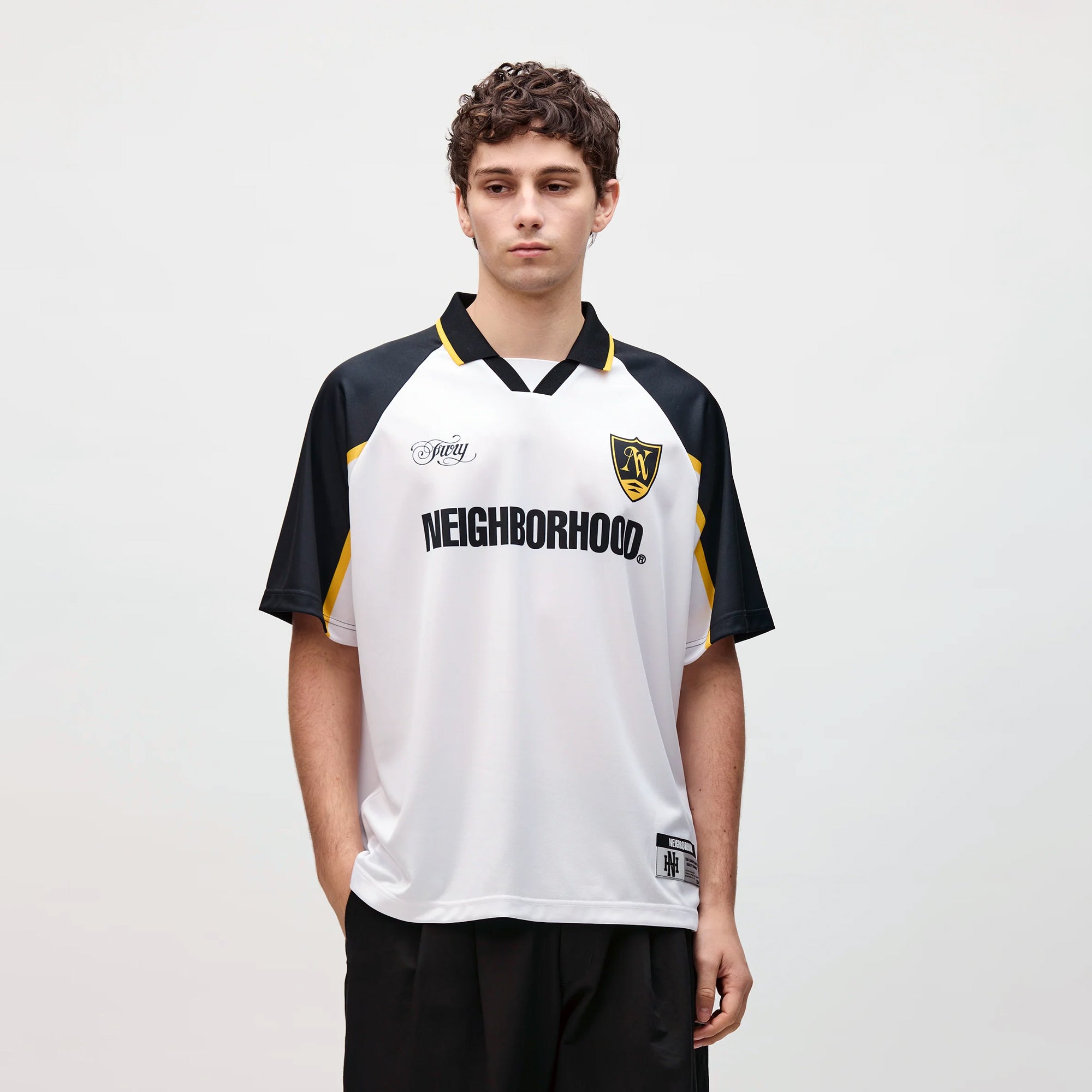 person wearing a white navy yellow jersey on a white background