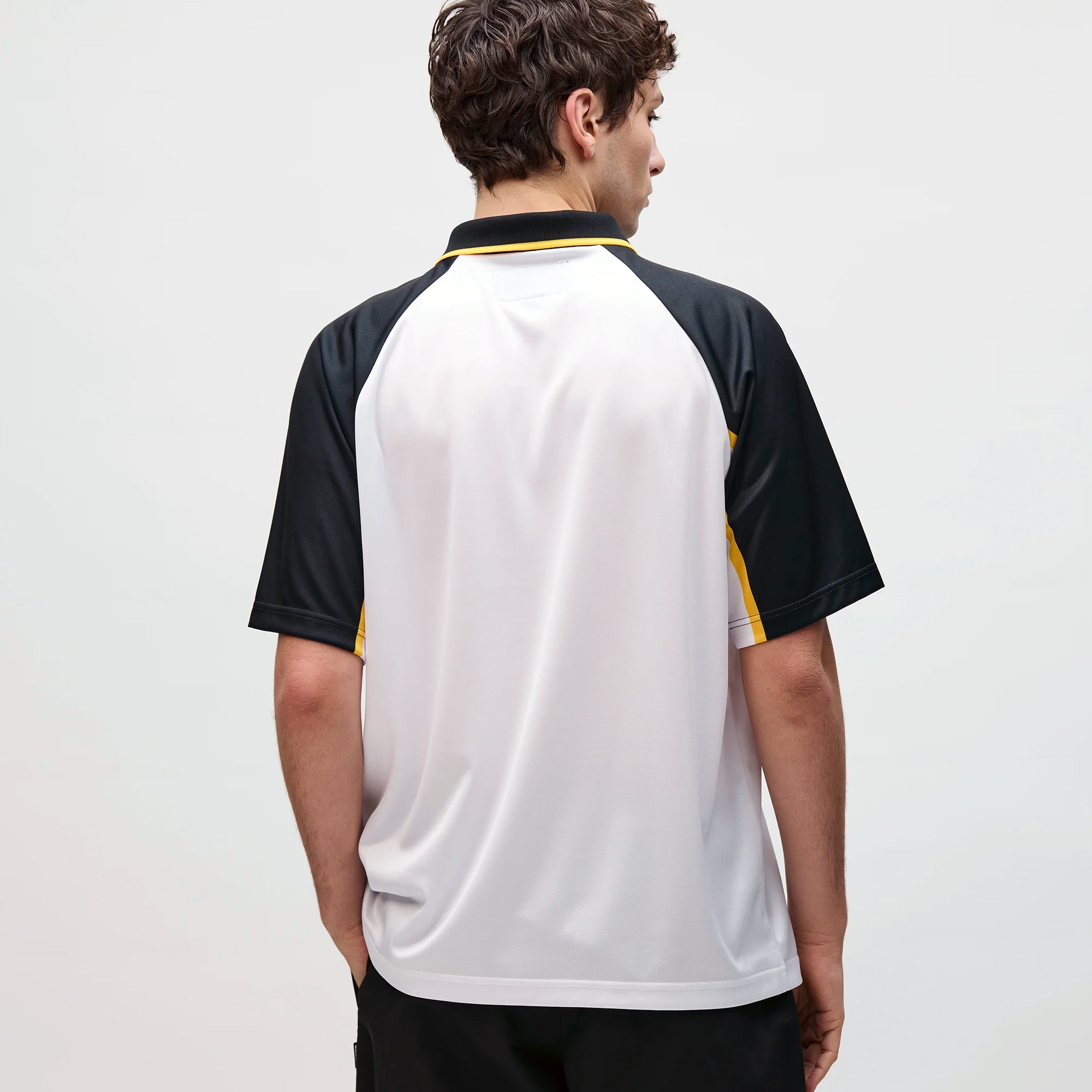 person wearing a white navy yellow jersey on a white background