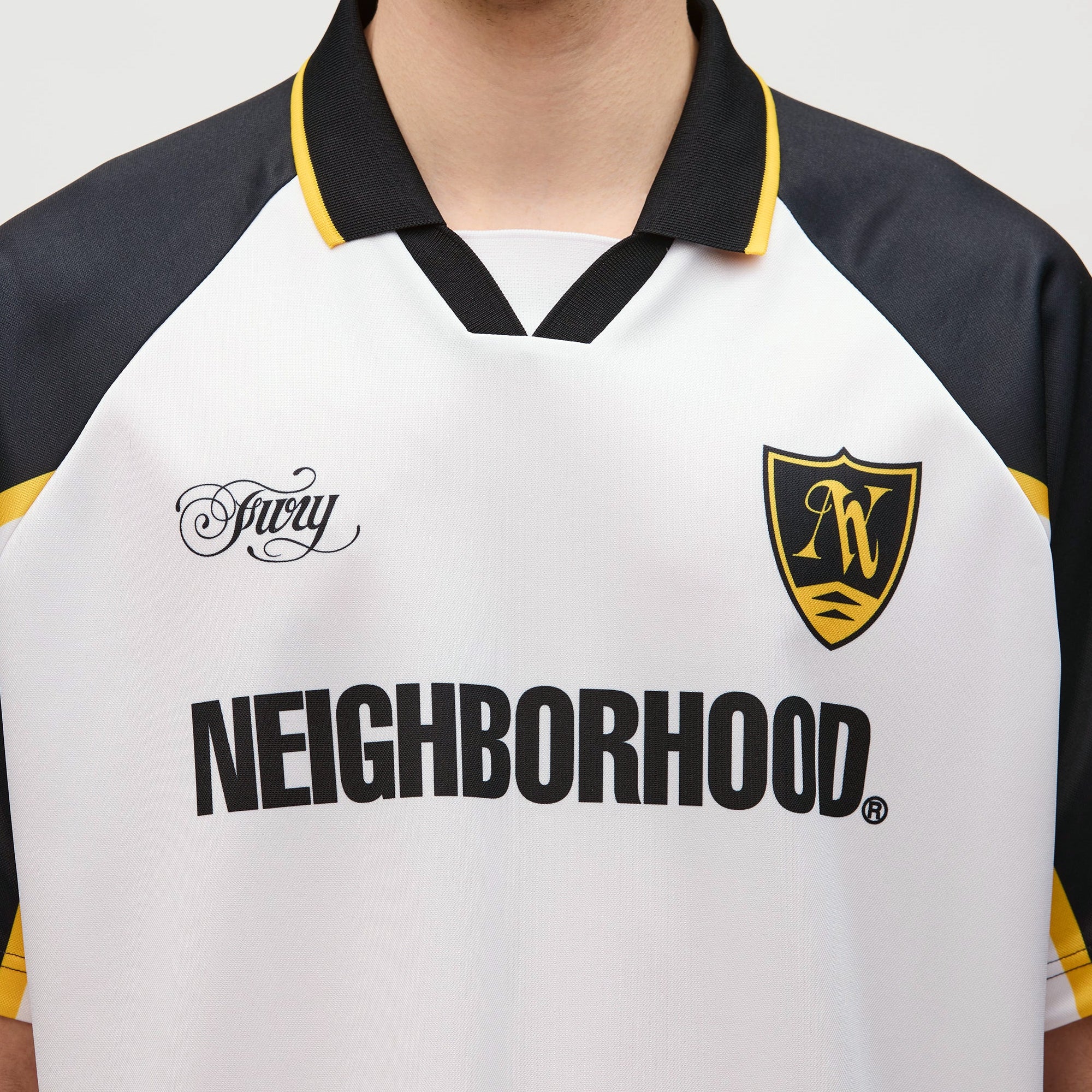 person wearing a white navy yellow jersey on a white background