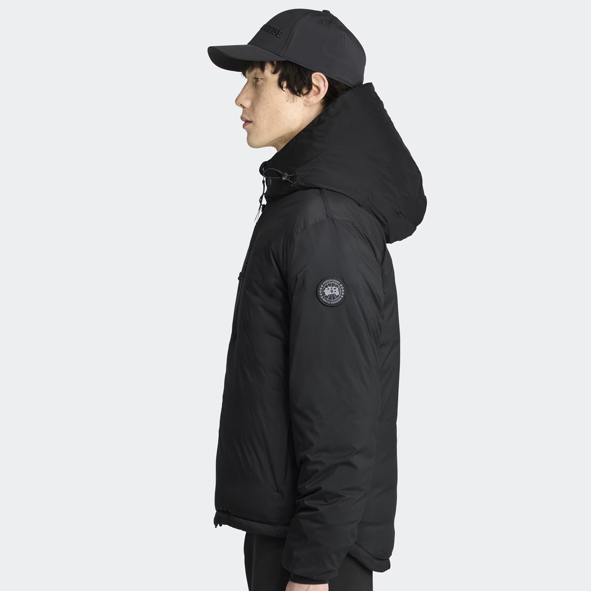 person wearing a black jacket on a white background
