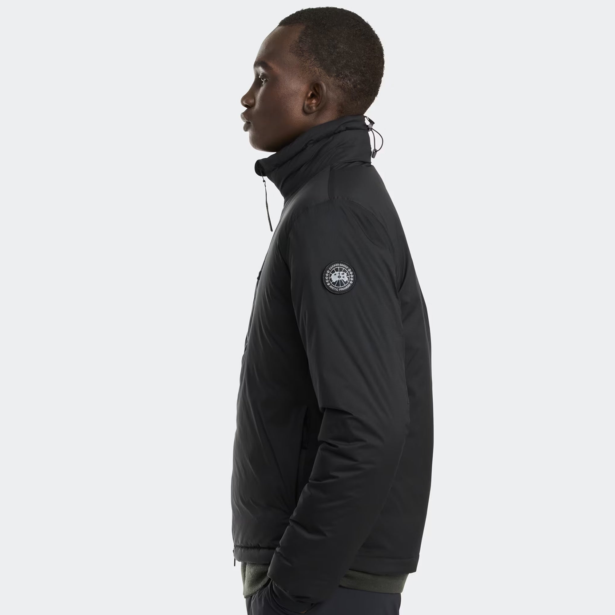person wearing a black jacket on a white background
