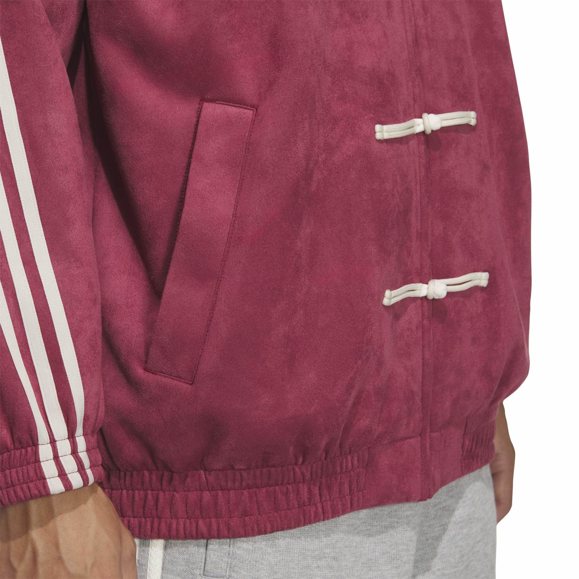 Person wearing burgundy and grey Jacket on a white background