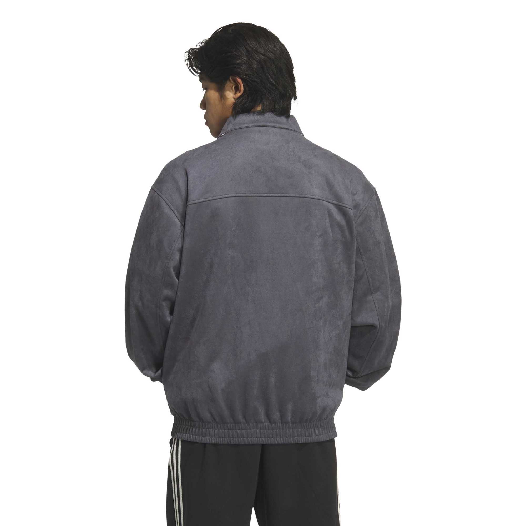 person wearing a grey jacket on a white background
