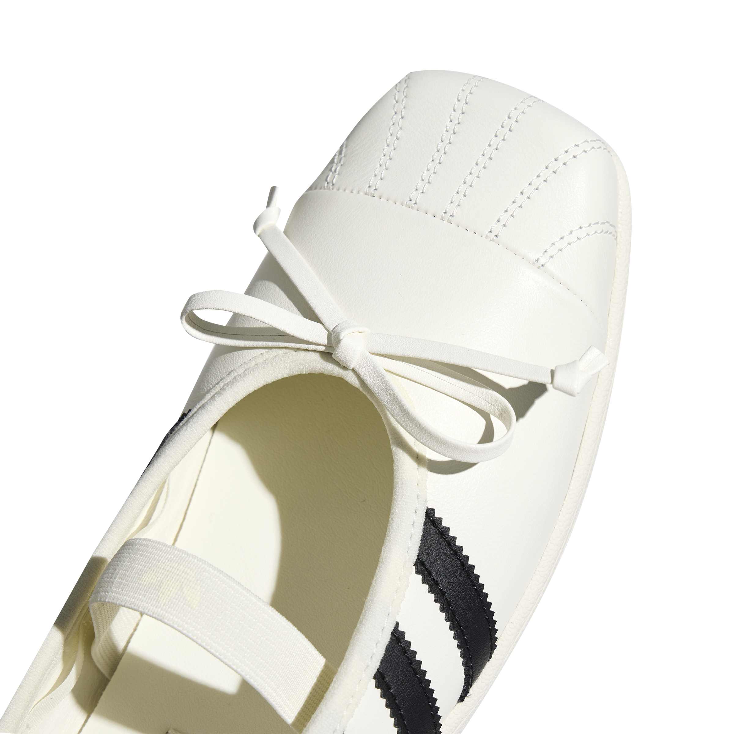 white and black ballet sneakers on a white background
