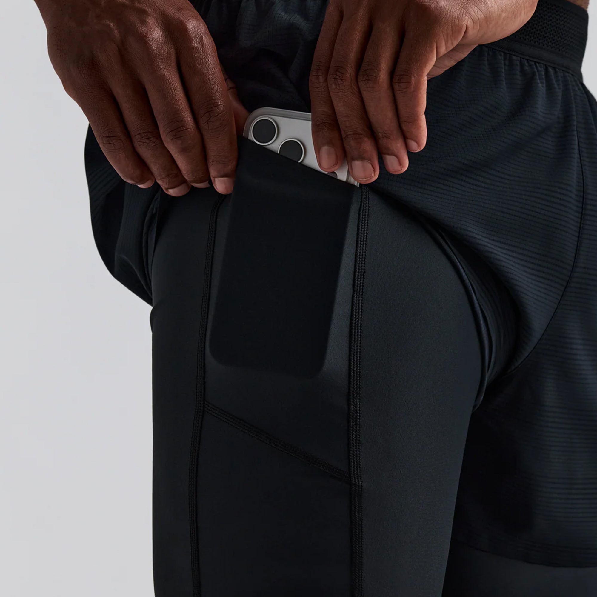 person wearing black shorts on a white background