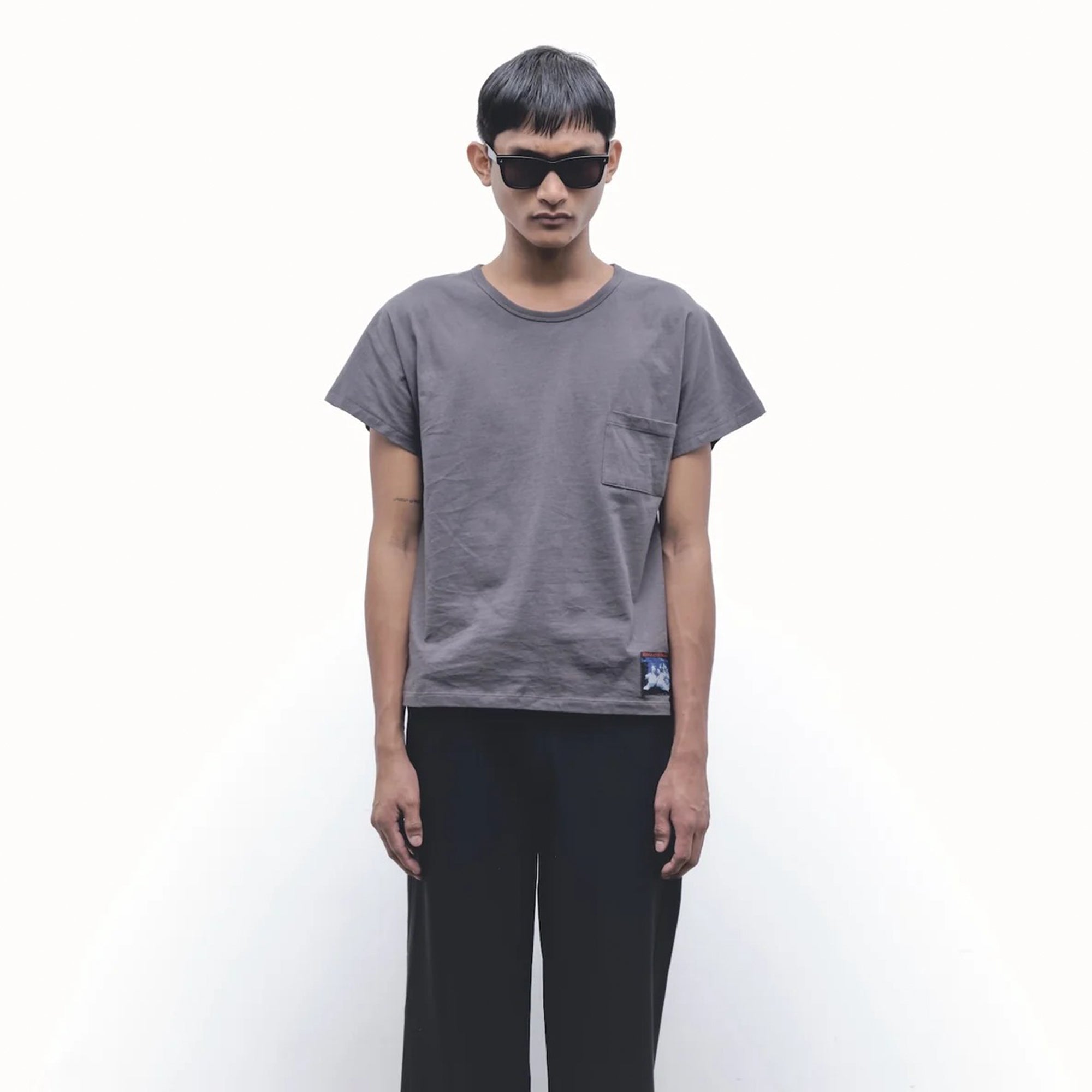 person wearing Grey t-shirt on a white background