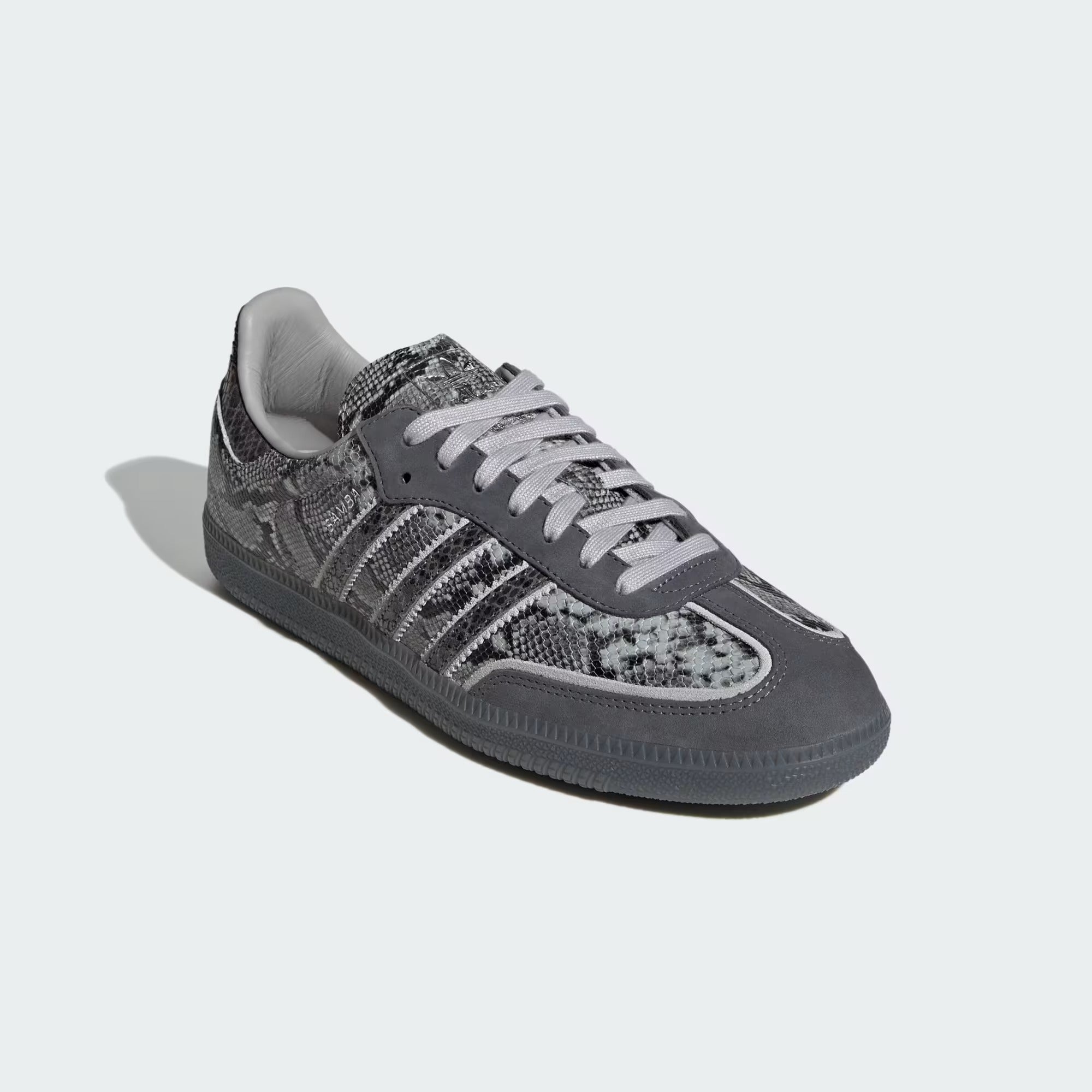 grey snake printed sneakers on a white background