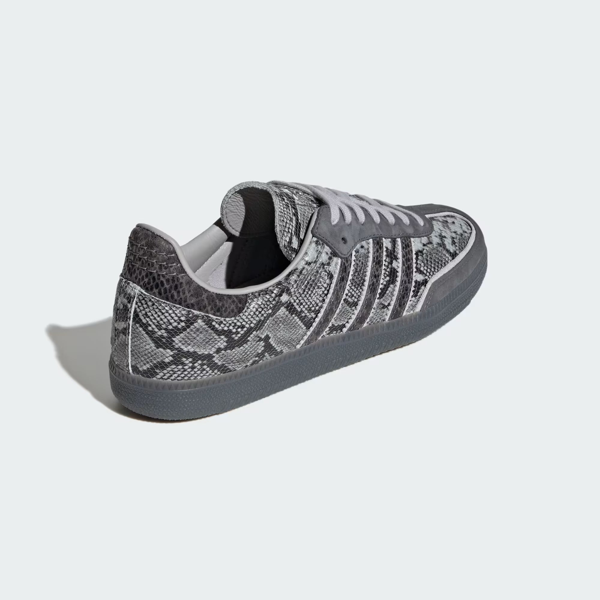 grey snake printed sneakers on a white background