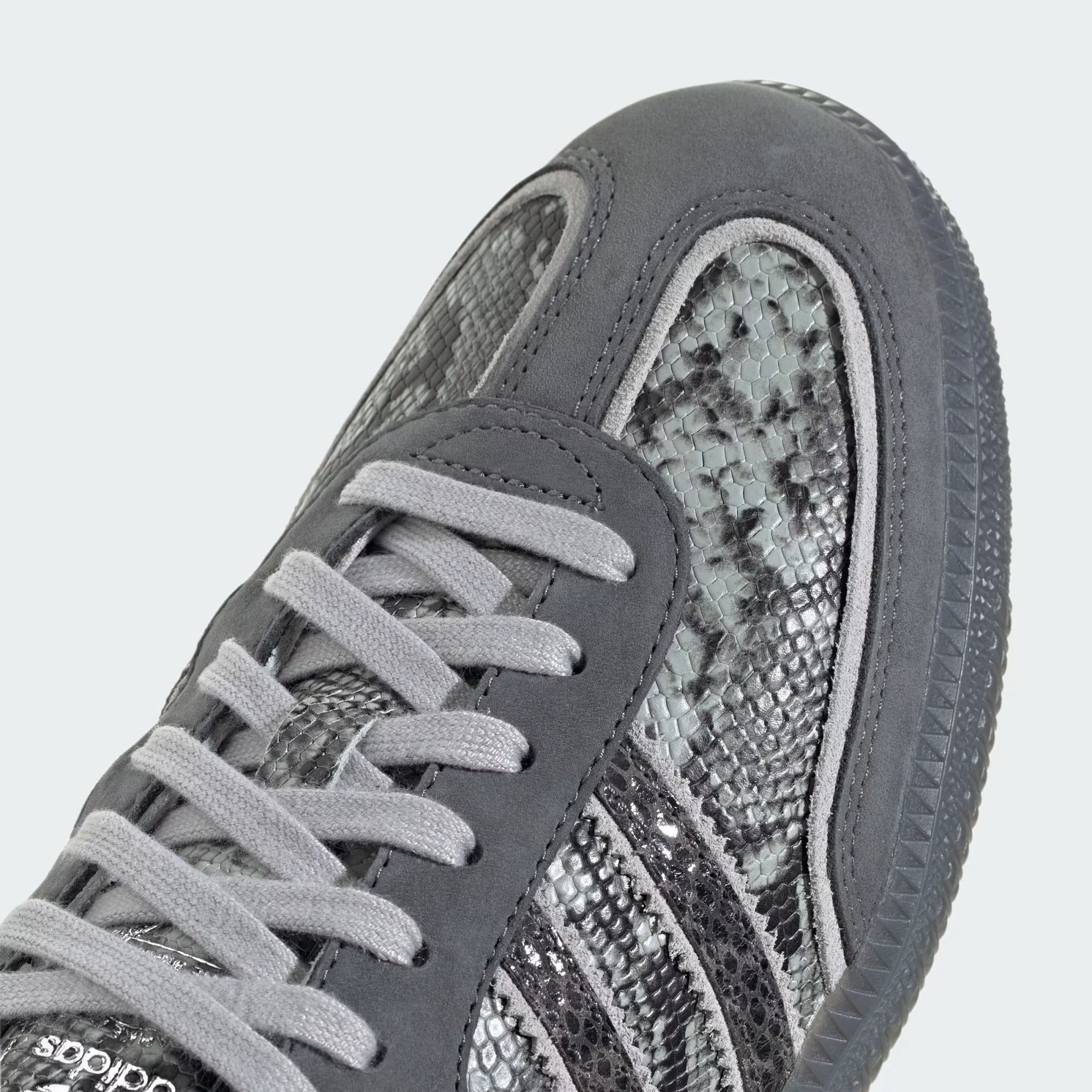 grey snake printed sneakers on a white background