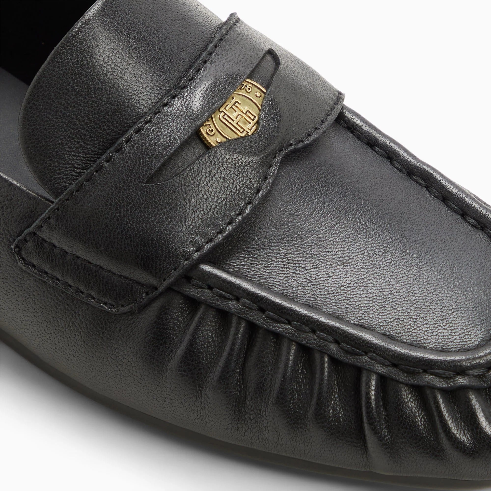 black penny loafers on a white background